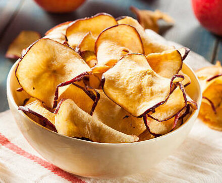 baked dehydrated apples chips in a bowl